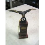 A desk ornament, in the form of a Third Reich blackened cast brass three dimensional eagle above a