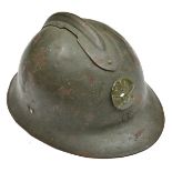 A French “Adrian” pattern steel helmet, stamped disc with “RF” grenade on crossed cannon, leather