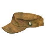 A Third Reich M43 D.A.K. floppy peaked cap, with plastic badge on oval green patch on the left side.