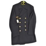 A German Navy double breasted blue deck coat, gilt anchor buttons and bronze finish breast badge.