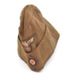 A Third Reich brown felt sidecap, with machine woven insignia on brown backing, the lining