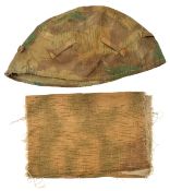 A camouflage helmet cover, with tabs for inserting additional grass, twigs etc; and a piece of