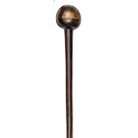 A Zulu polished darkwood knobkerry, almost spherical head, flared end to staff, 30” overall. GC,