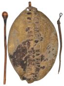 A Zulu hide shield, slotted central panel, 27” overall (staff missing) good patina; a knobkerry with