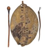 A Zulu hide shield, slotted central panel, 27” overall (staff missing) good patina; a knobkerry with