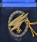 A Third Reich paratrooper’s badge, with WM wreath, brass eagle, wide hinge and round pin, the