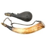 A powder horn, wooden base plug, brass studs around base, bone muzzle plug on chain, 11” overall;