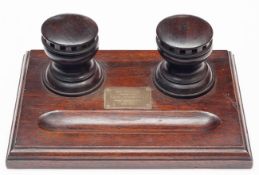 An interesting polished dark oak desk stand from the timbers of HMS Britannia, with 2 inkwells in