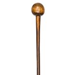 A Zulu polished wooden knobkerry, almost spherical head, flared end to staff, 26” overall. GC,