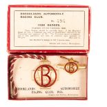 A boxed pair of enamelled Brooklands Automobile Racing Club badges for 1936 by Marples & Beasley,