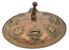 A Tibetan ceremonial sheet copper shield, with 4 prominent applied demons’ heads interspersed with 4
