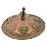 A Tibetan ceremonial sheet copper shield, with 4 prominent applied demons’ heads interspersed with 4