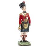 A well modelled painted Sitzendorf porcelain figure “The Black Watch” officer c 1815 in full dress