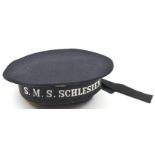A German sailor’s cap, with metal cockade and cap tally to SMS Schlesien. Basically GC, the tally