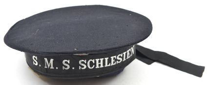 A German sailor’s cap, with metal cockade and cap tally to SMS Schlesien. Basically GC, the tally