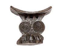 A Zulu carved darkwood head rest, simple carved and pierced decoration of concentric circles and
