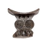 A Zulu carved darkwood head rest, simple carved and pierced decoration of concentric circles and