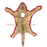 A bass drummer’s cheetah skin apron, on scarlet cloth backing, with aperture for drummer’s head, the