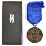 A Third Reich SS 8 year service bronze medal, in its carton with silver SS runes on the lid, and