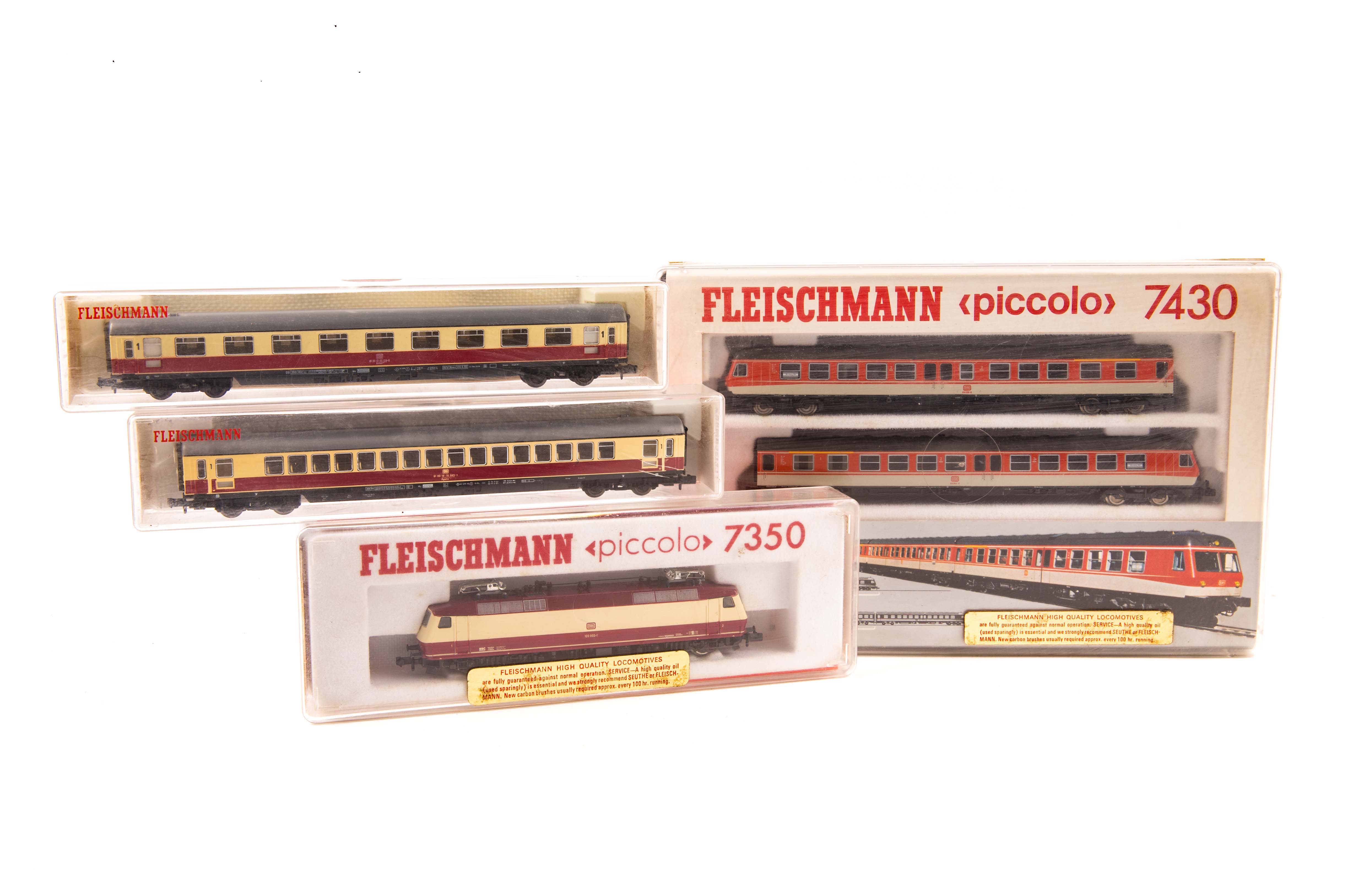 9 N gauge locomotives and coaches by Fleischmann, Minitrix and Lima. A DB 3 car diesel multiple unit