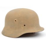 A Third Reich M35 steel helmet, with remnants of leather lining and very rusty steel lining band (no