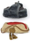 A grey faux fur hat, with quilted lining, rubber stamped “1943/WH” and serial number; and a