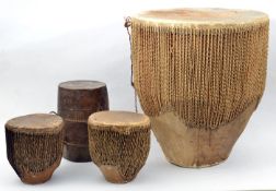 A large African drum, of rounded tapered form, skin top and base, cord and hide body, diam 20”,