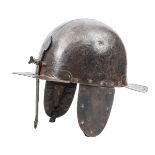 A mid 17th century siege helmet, the heavy 2 piece domed skull having front and rear peaks pierced