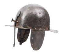 A mid 17th century siege helmet, the heavy 2 piece domed skull having front and rear peaks pierced