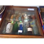 DISPLAY CASE OF GLASS AND STONEWARE BOTTLES D2