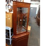 A CORNER CABINET AND A WHITE STOOL