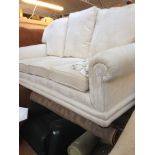 A CREAM FLORAL PATTERNED 3 SEATER SOFA