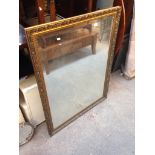 A LARGE GOLD FRAMED MIRROR