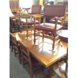 A LIGHT OAK DRAWER LEAF REFECTORY TABLE WITH 6 RED LEATHER STUDDED OAK CHAIRS