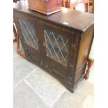 AN OAK LEADED GLASS BOOKCASE H99CM W106CM D33CM