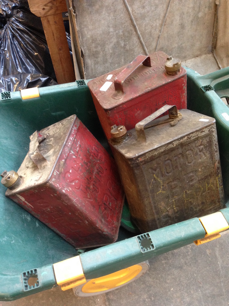 A LAWN FEEDER, PLASTIC WHEEL BARROW AND 3 OLD JERRY CANS