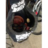 A WHEELY BAG WITH SOFT TOYS, HELMET, RIDING HAT ETC