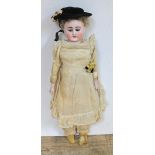 A Continental porcelain headed doll with open shut blue glass eyes circa 1900, cream leather body