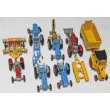 7 Corgi Toys tractors with various accessories.