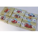 A group of eight boxed model Corgi fire engines.