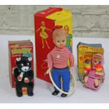 Three wind up toys comprising a Japanese "Hungry Wind Up Cub" with box, a German Max Carl wind up