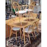 An Ercol blonde elm and beech extending dining table and six chairs, min. table dimensions; length