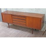 A Danish teak sideboard circa 1960s having sliding doors either side central drawers, stamped '