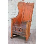 A 19th Century West Lancashire pine and elm seated wing back rocking lambing chair with drawer,