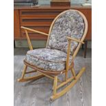 An Ercol blonde elm and beech rocking chair, width 69cm, depth 77cm & height 83cm.