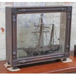 A 2 master model sailing ship within a Victorian scrumble pine display glass, 71cm x 63cm.