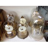 SIX REVOLVING PENDULUM CLOCKS UNDER DOMES F4