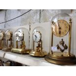 FIVE REVOLVING PENDULUM CLOCKS UNDER DOMES G5