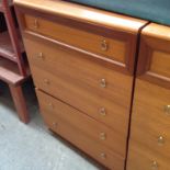 A TALL CHEST OF DRAWERS