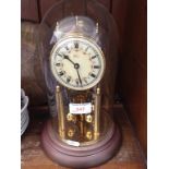 REVOLVING PENDULUM CLOCK UNDER A DOME. H30CM